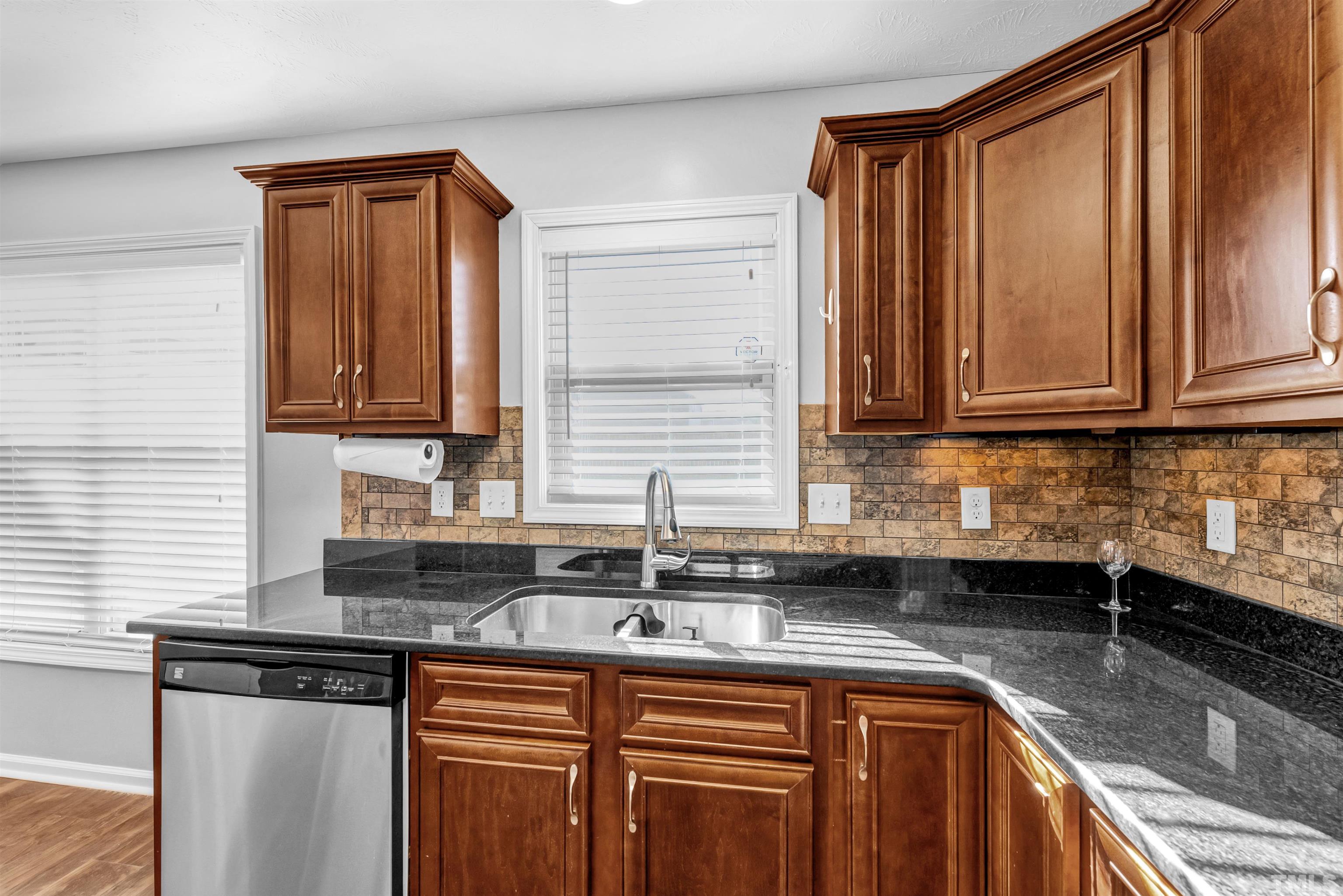 707 Botanical Court Bunnlevel, NC 28323 - Photo 12 of 31 a kitchen with stainless steel appliances granite countertop a sink stove and cabinets