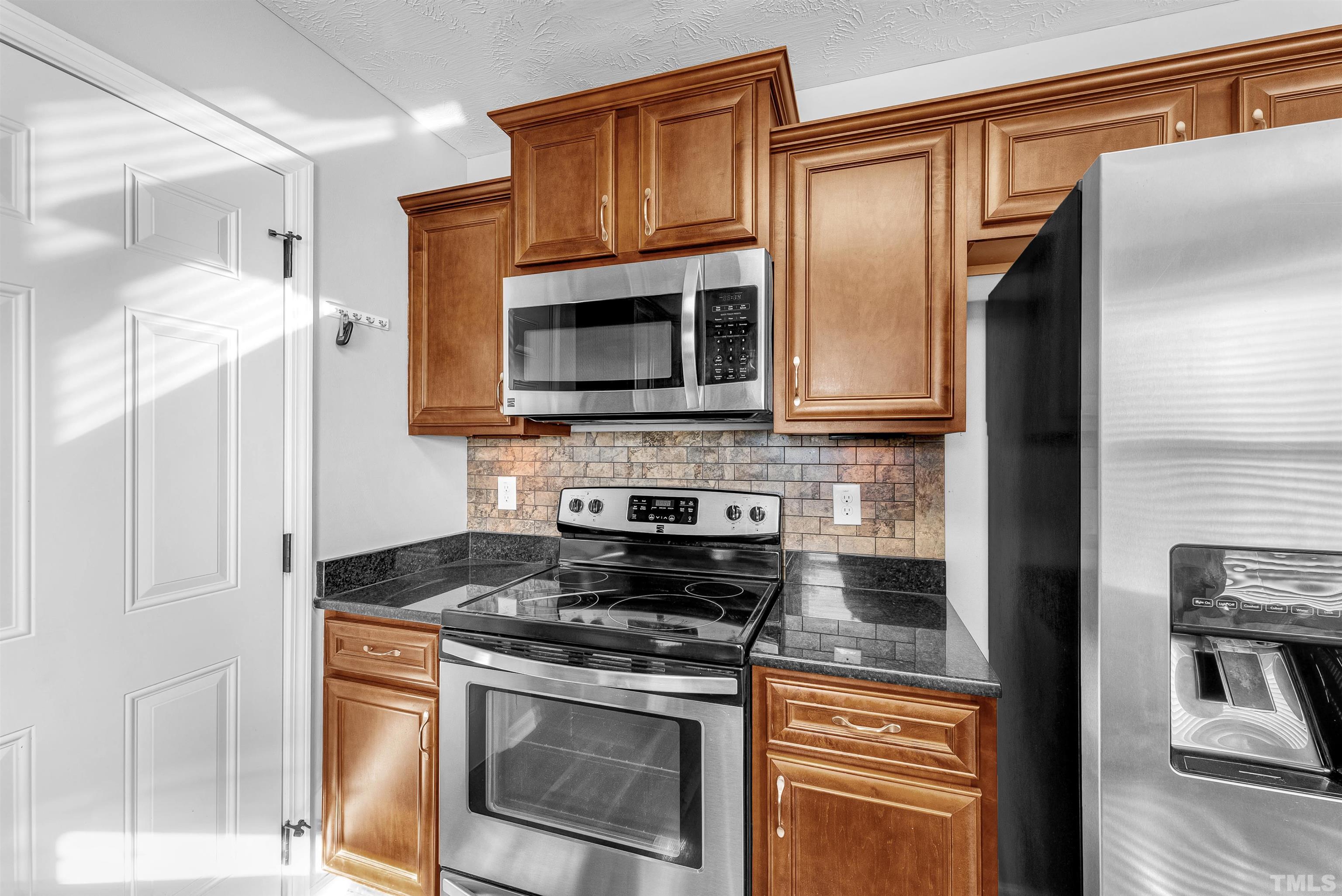 707 Botanical Court Bunnlevel, NC 28323 - Photo 13 of 31 a kitchen with stainless steel appliances granite countertop a refrigerator stove and microwave