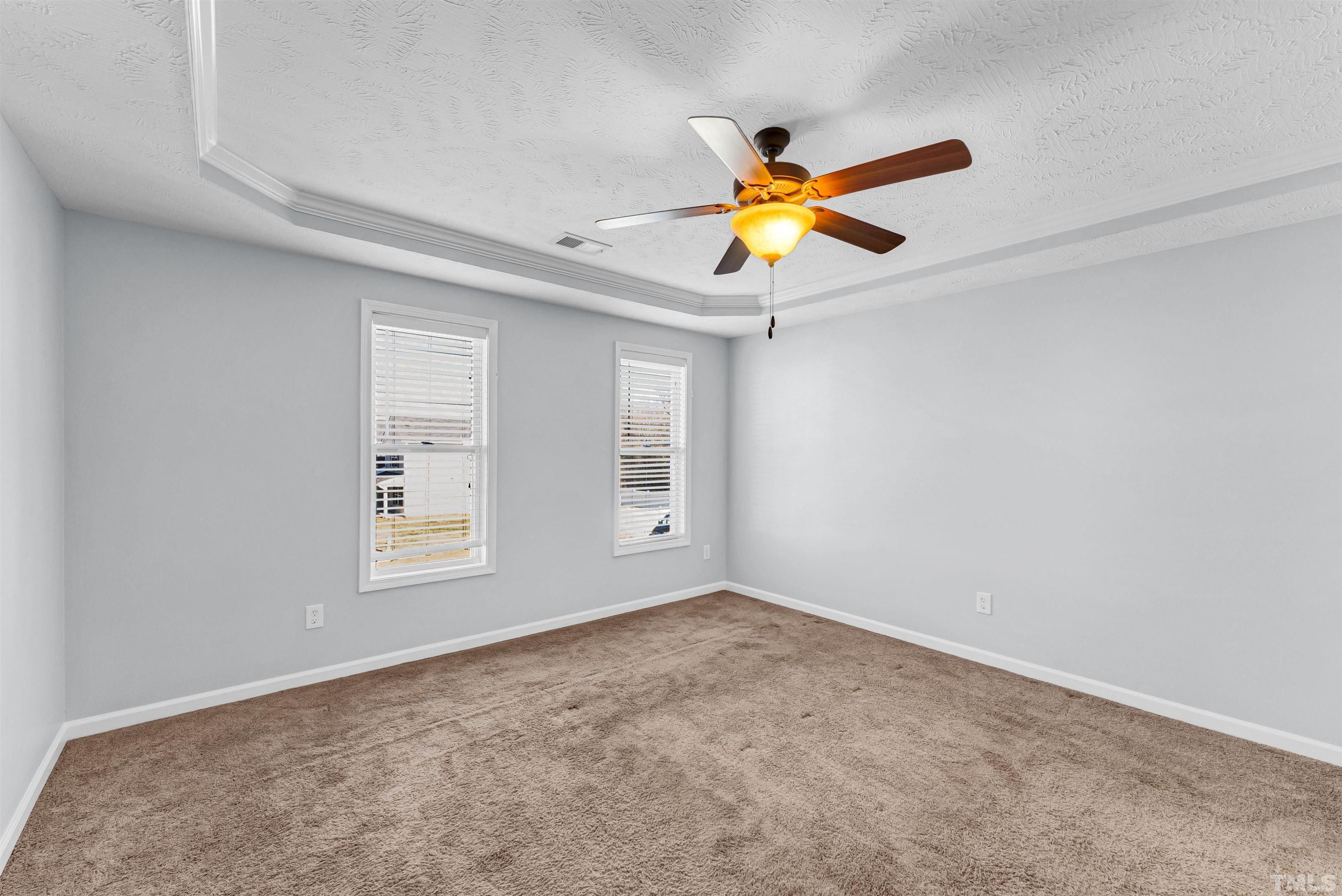 707 Botanical Court Bunnlevel, NC 28323 - Photo 14 of 31 an empty room with window and ceiling fan