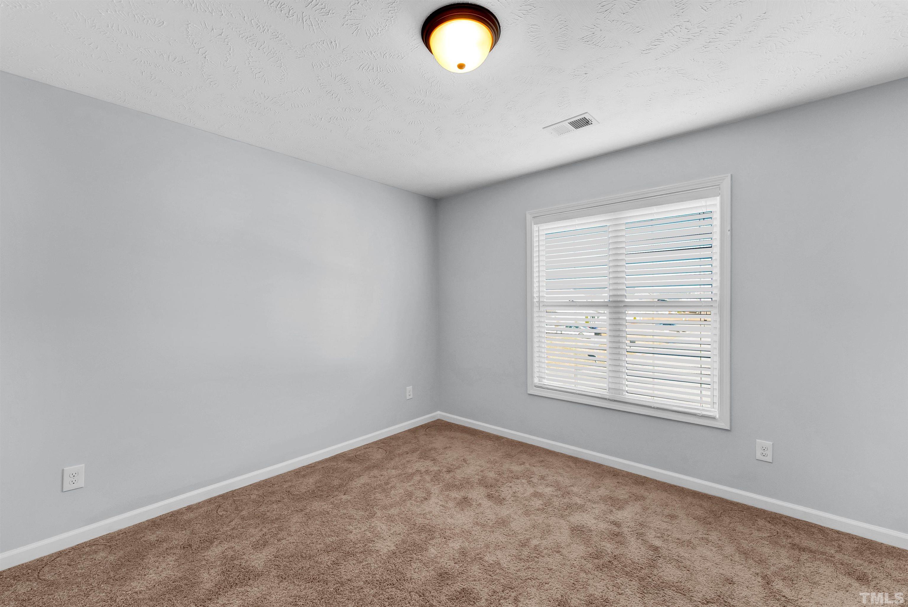707 Botanical Court Bunnlevel, NC 28323 - Photo 17 of 31 an empty room with windows and closet