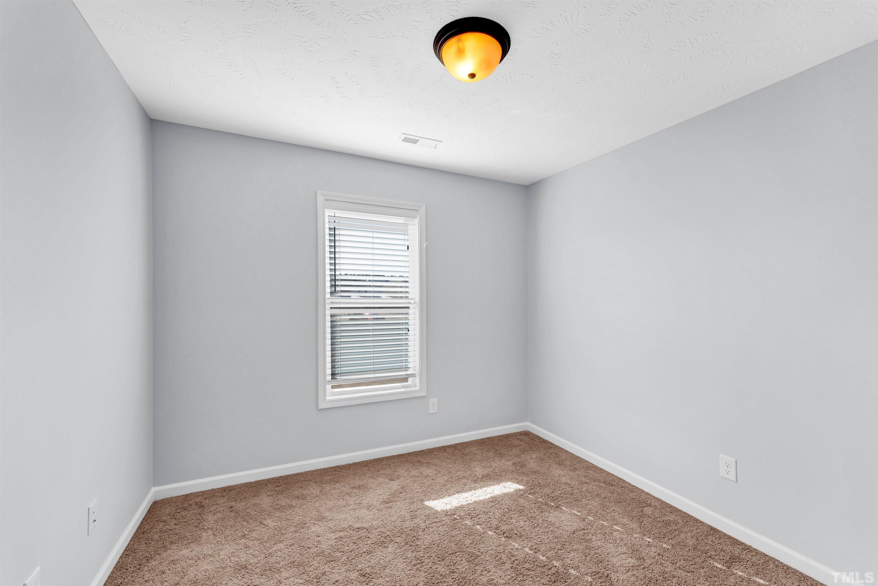 707 Botanical Court Bunnlevel, NC 28323 - Photo 19 of 31 an empty room with a window
