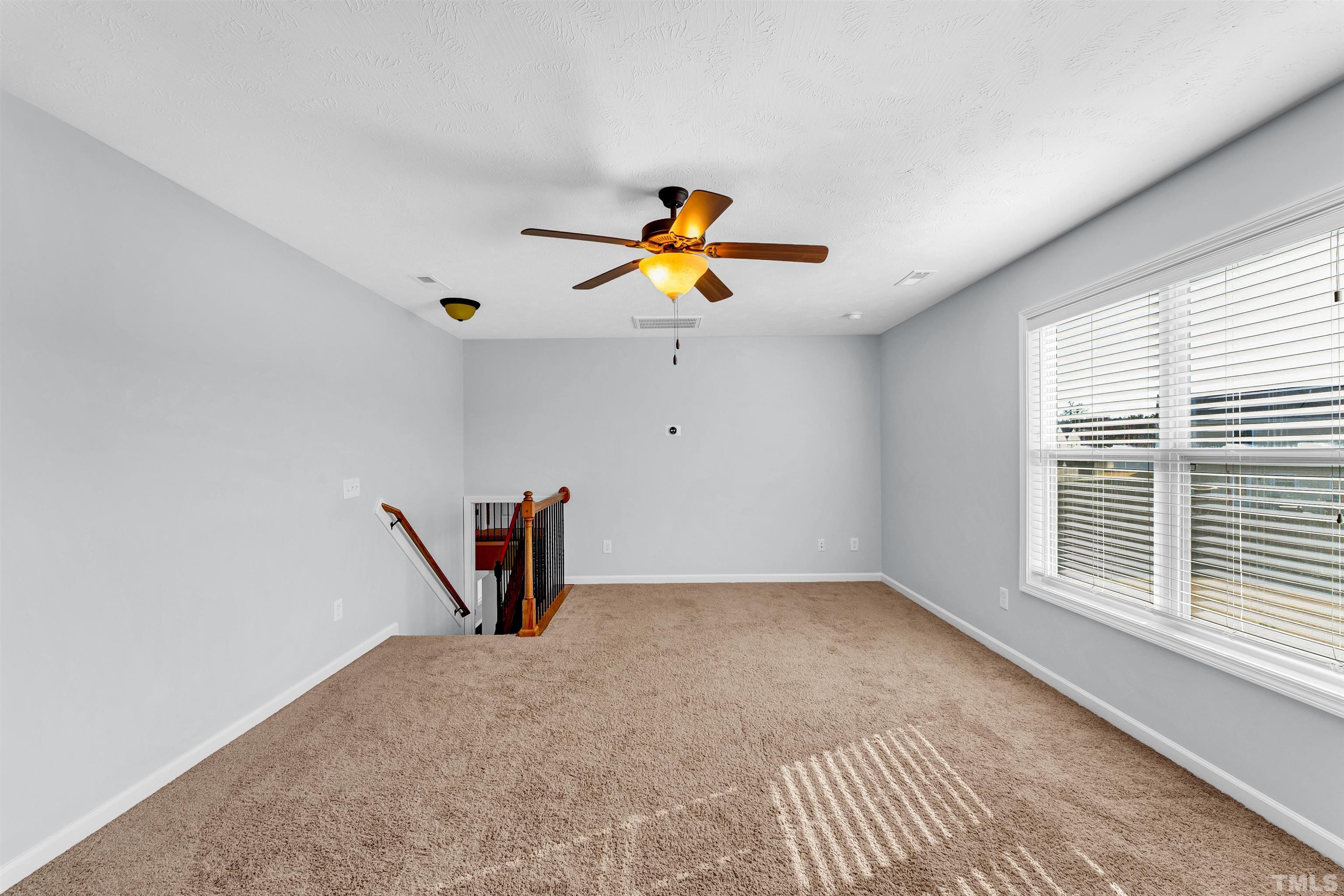 707 Botanical Court Bunnlevel, NC 28323 - Photo 23 of 31 wooden floor in an empty room with a window