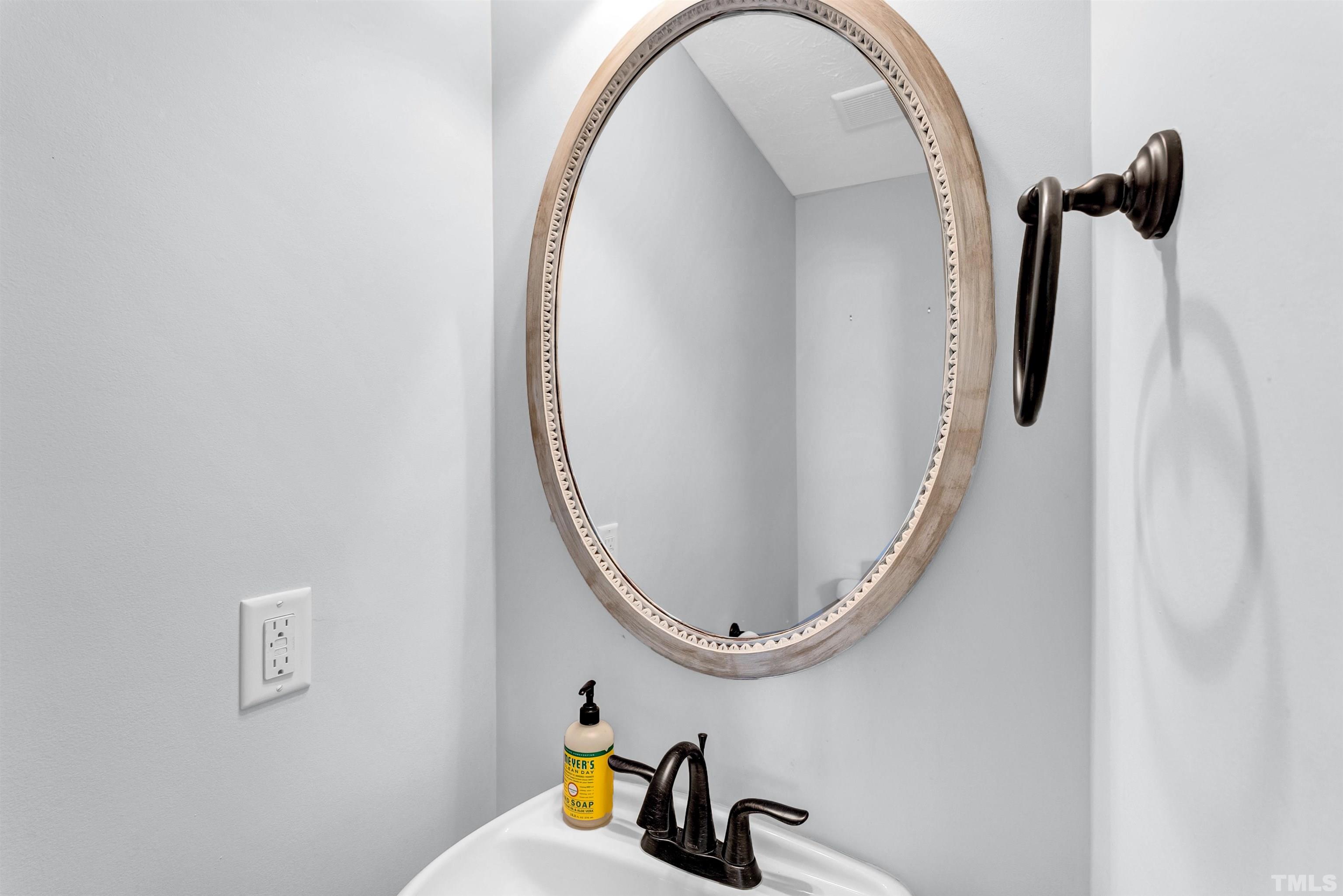 707 Botanical Court Bunnlevel, NC 28323 - Photo 24 of 31 a bathroom with a sink and a mirror