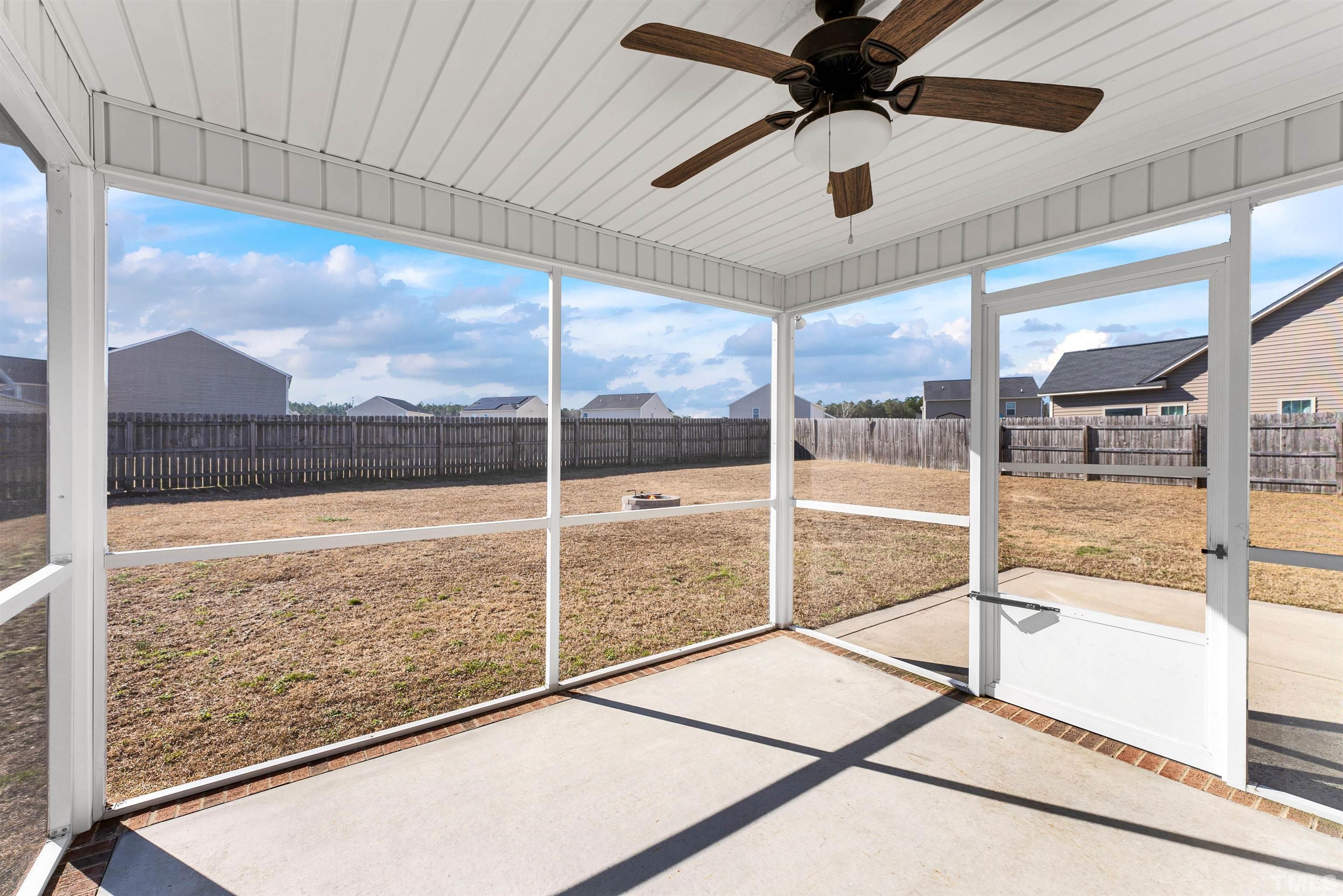 707 Botanical Court Bunnlevel, NC 28323 - Photo 26 of 31 a living room with a floor to ceiling window and a ceiling fan