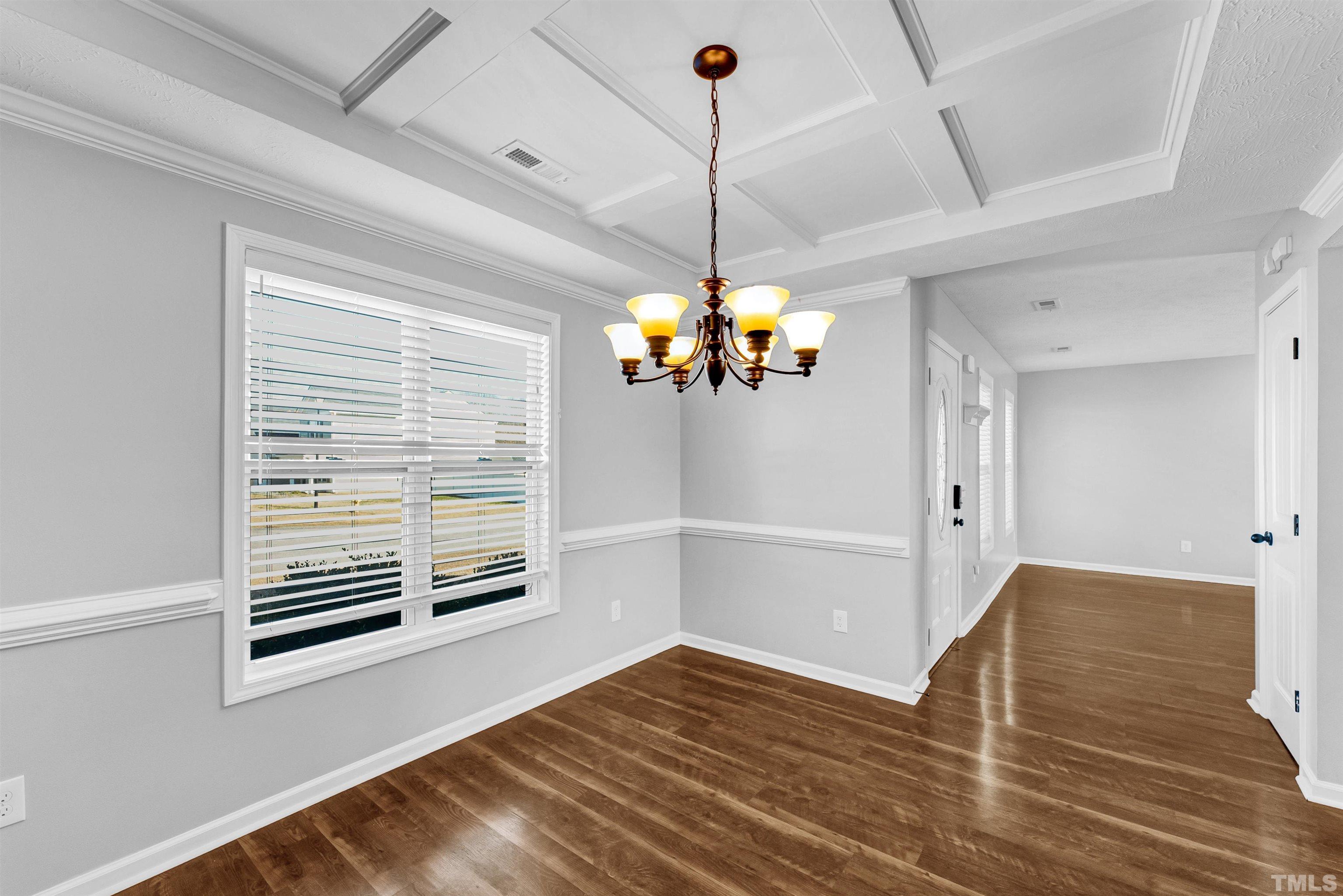 707 Botanical Court Bunnlevel, NC 28323 - Photo 9 of 31 a view of a livingroom with wooden floor and a ceiling fan