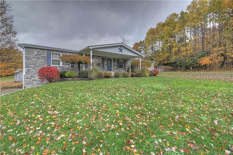 Beautiful stone front and sides boasting covered front porch and expansive front lawn. 