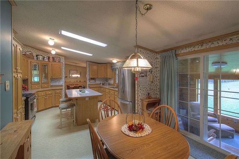 Breakfast Nook. Kitchen with seating island, abundant cabinet space, pantry!  Access through sliding glass doors to the SunRoom.