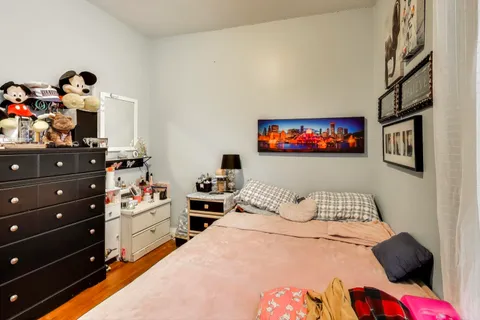 a bedroom with a bed and a bookshelf