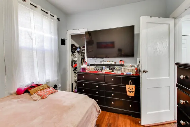 a bedroom with a bed and a flat screen tv