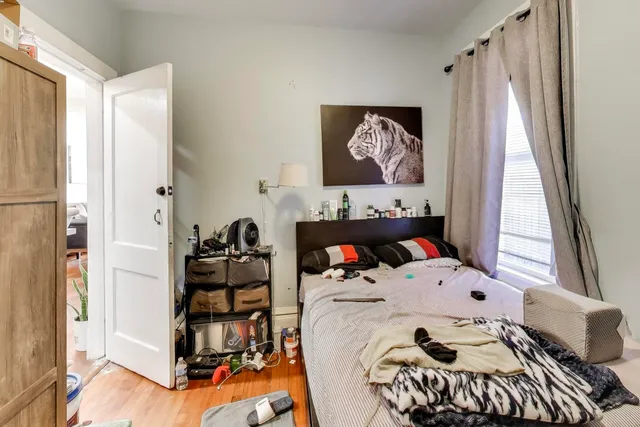 a bedroom with a bed and a window