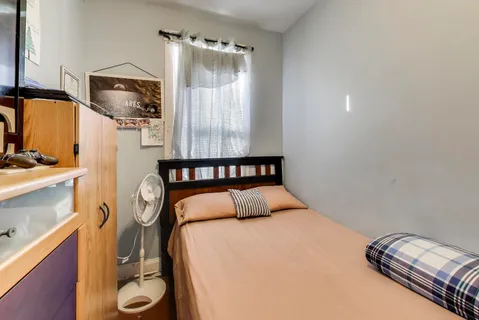 a bedroom with a bed and a mirror