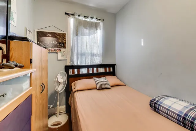 a bedroom with a bed and a mirror