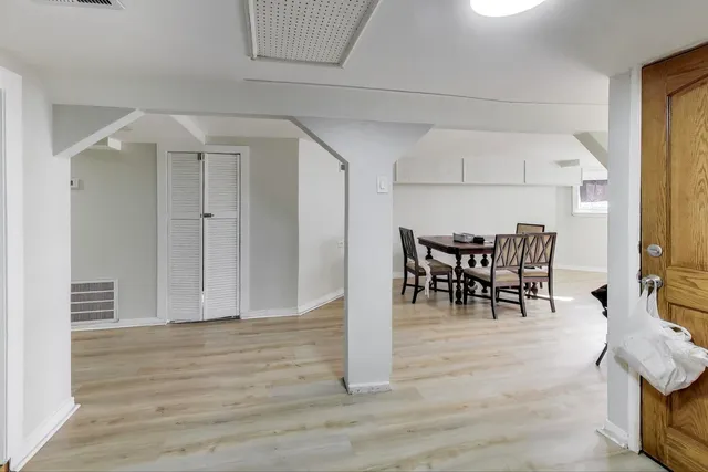 a dining room with furniture and wooden floor