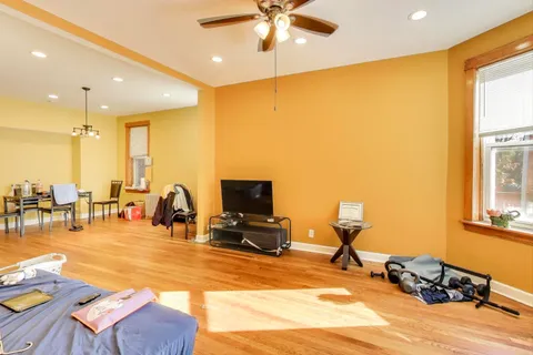 a view of a livingroom with furniture and a flat screen tv