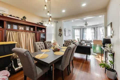 a view of a dining room with furniture window and wooden floor