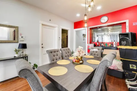 a view of a dining room with furniture and wooden floor
