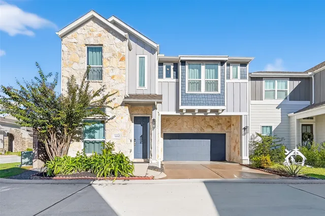 a front view of a house with a yard and a garage