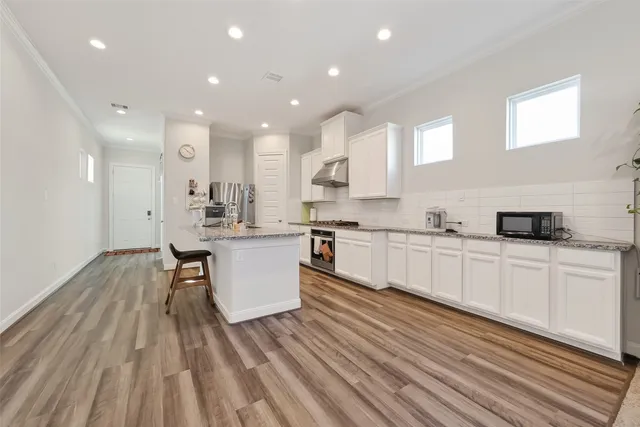 a kitchen with white cabinets stainless steel appliances and sink