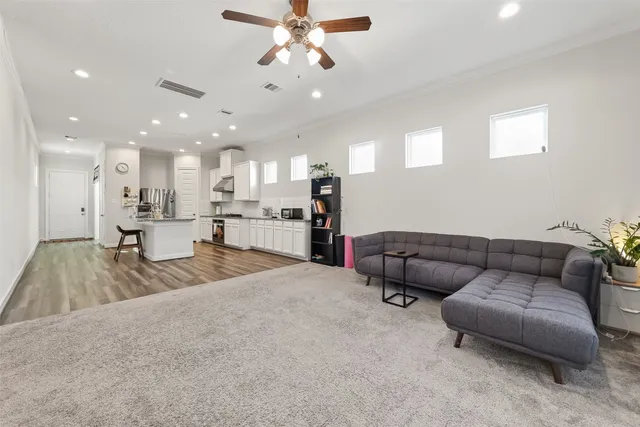 a living room with furniture and kitchen view