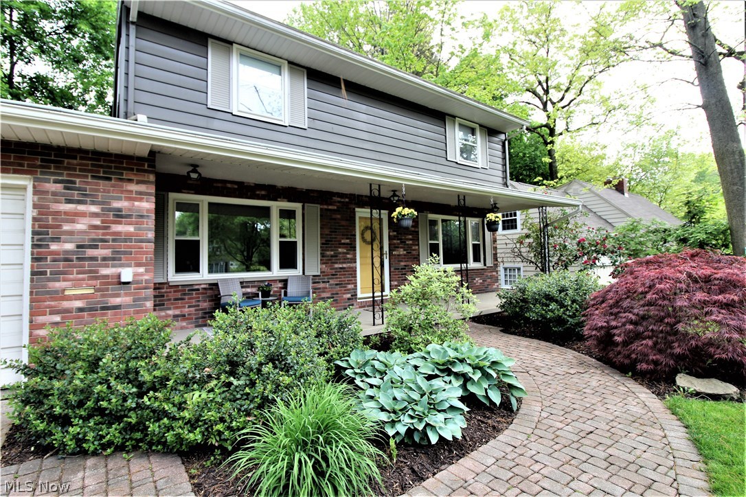 2887 Lee Road Silver Lake, OH 44224 - Photo 2 of 24 Welcoming Front Porch Surrounded by Beautiful Gardens and Brick Paver Walkway