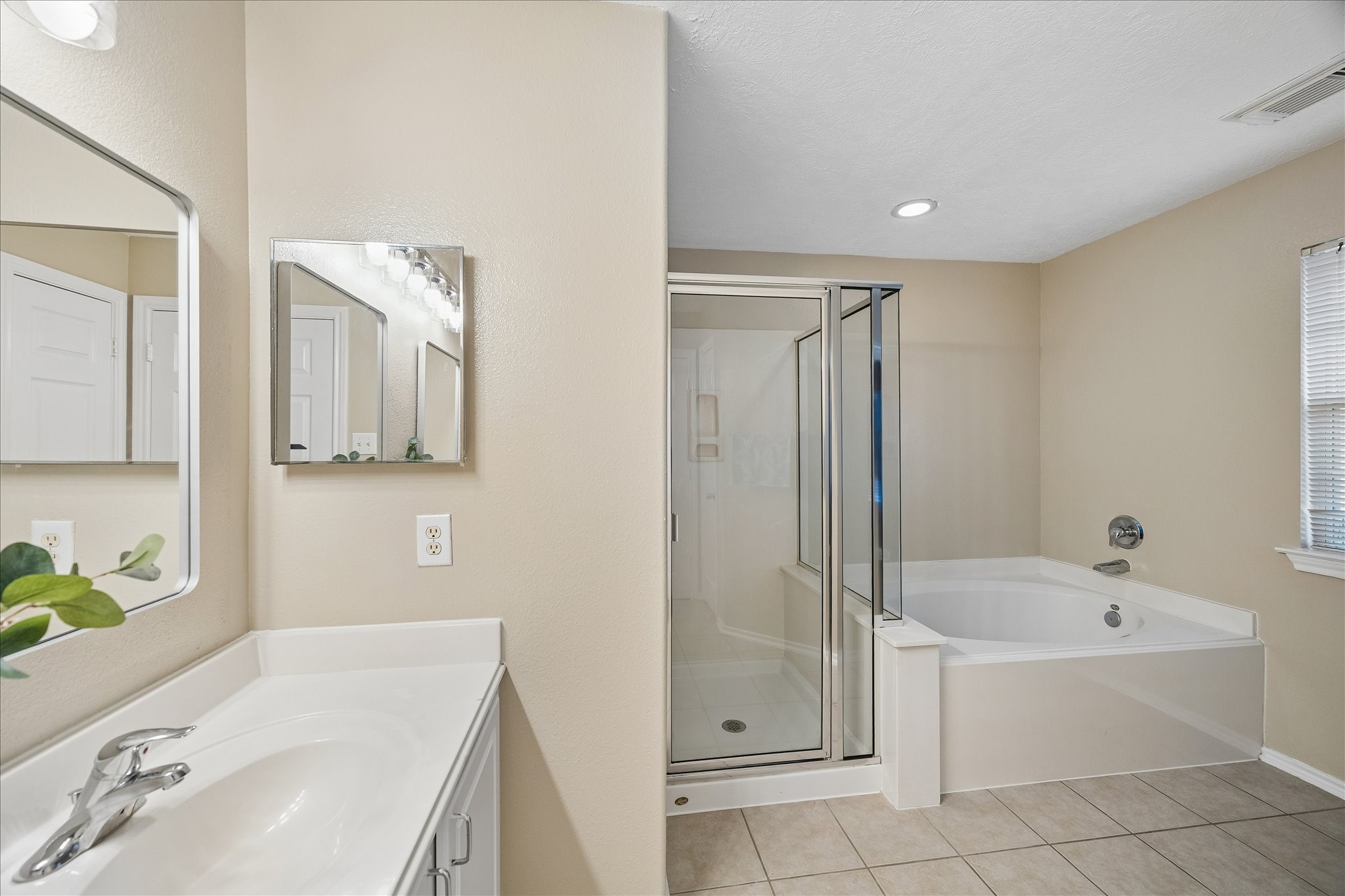 14334 Fairbuff Lane Houston, TX 77014 - Photo 10 of 15 a bathroom with a tub sink and mirror