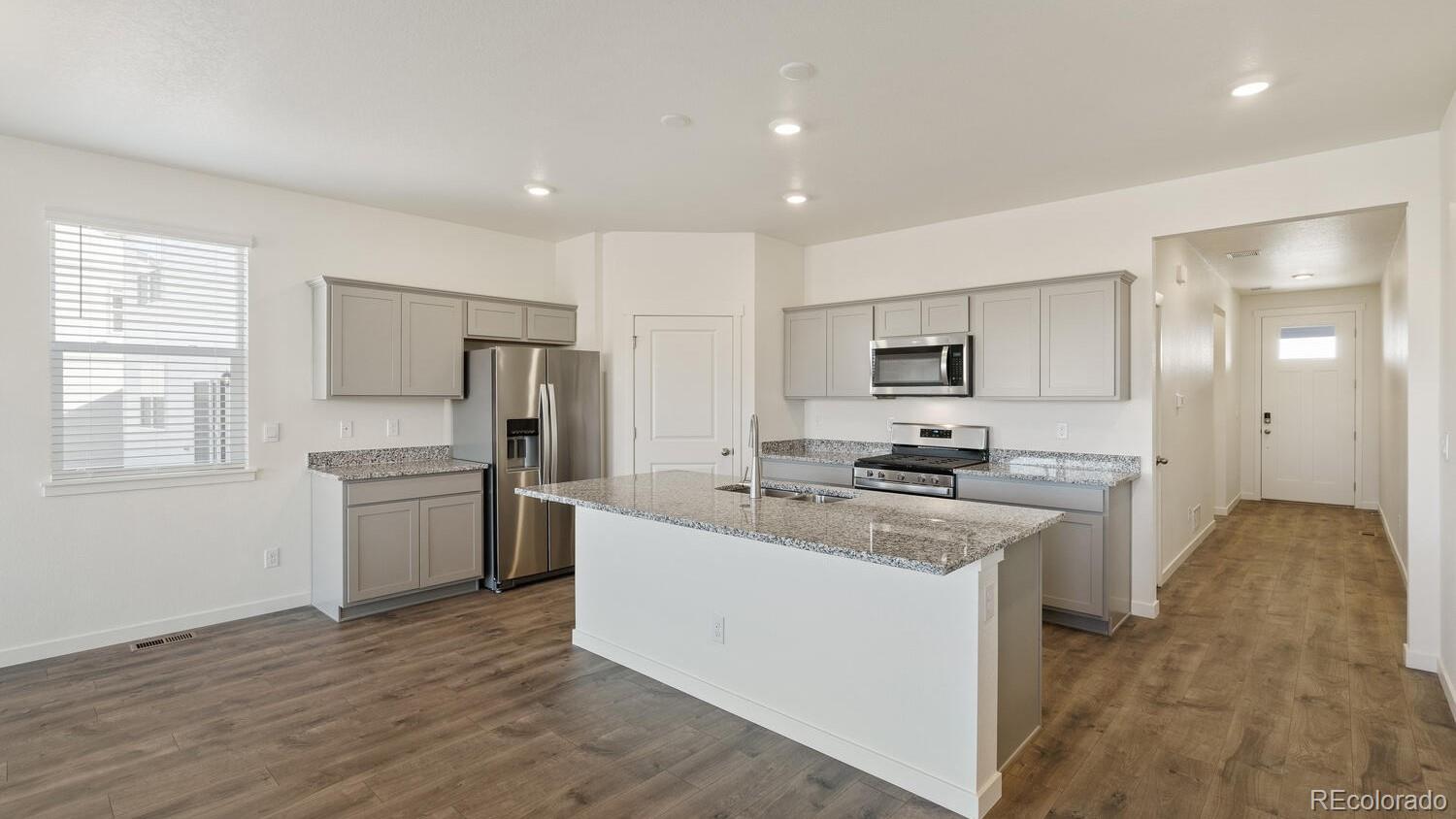 950 London Way Severance, CO 80550 - Photo 11 of 21 a kitchen with a stove a sink and a refrigerator