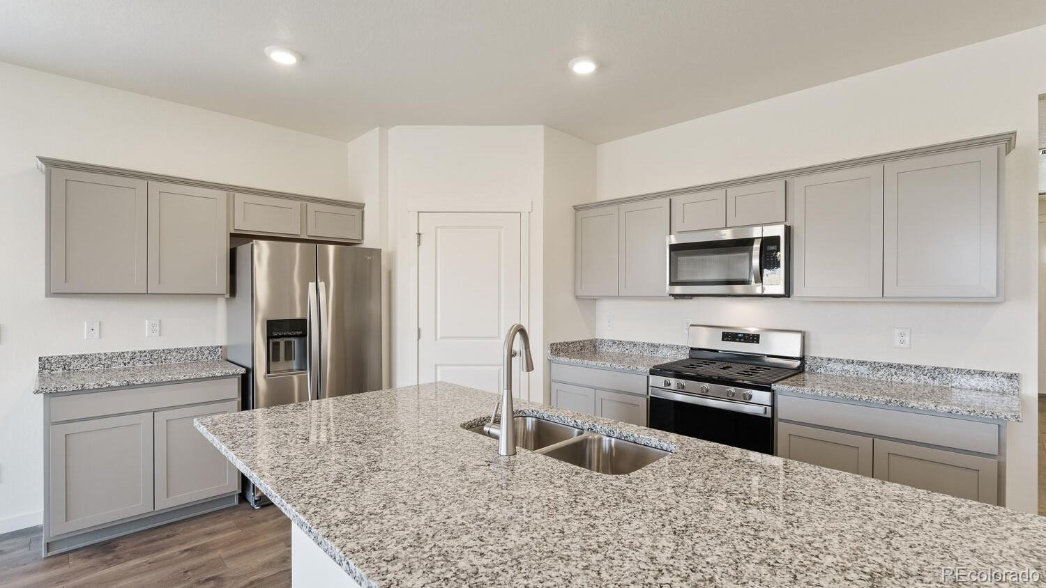 950 London Way Severance, CO 80550 - Photo 12 of 21 a kitchen with stainless steel appliances granite countertop a refrigerator stove microwave and sink
