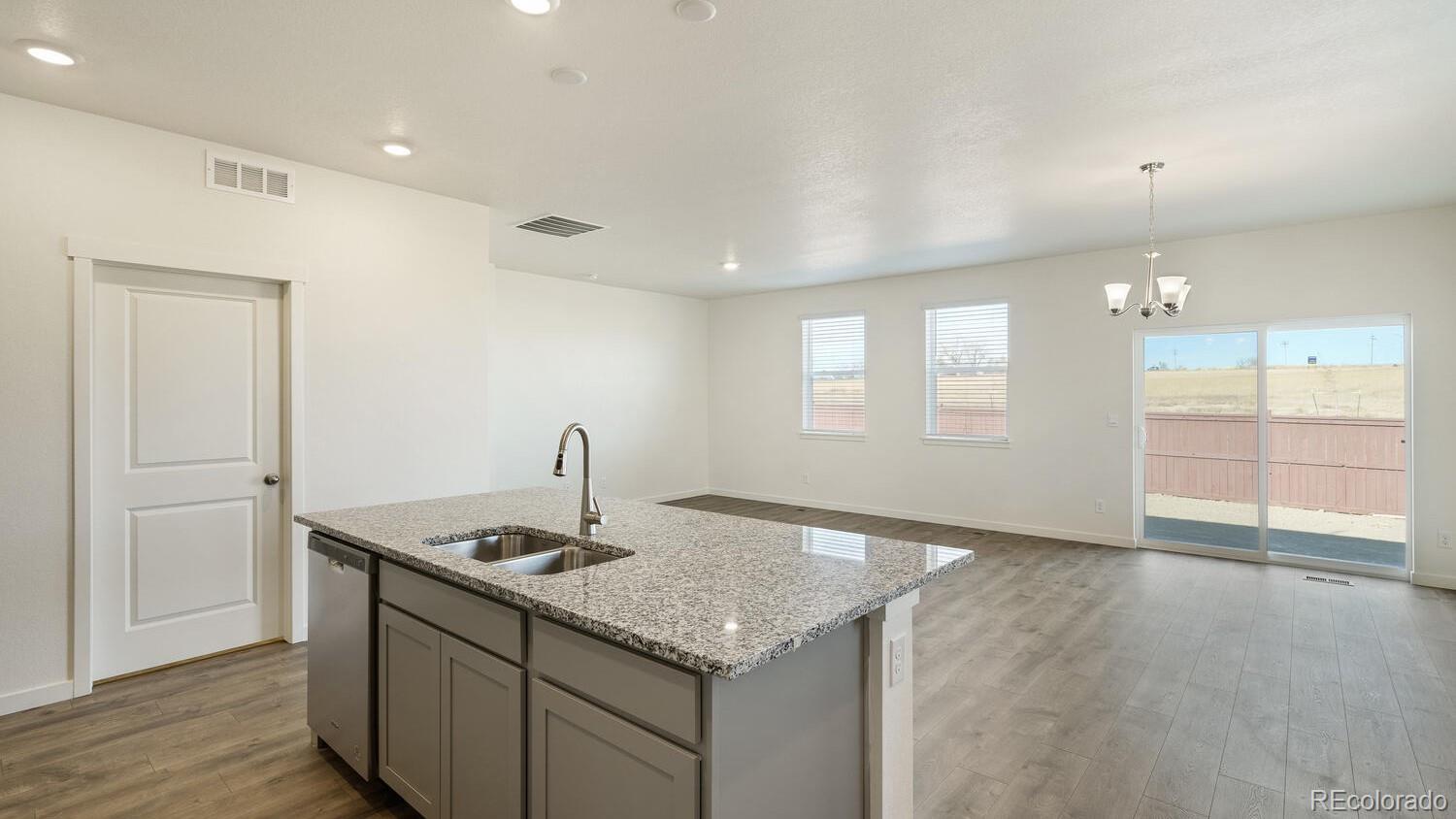 950 London Way Severance, CO 80550 - Photo 13 of 21 a kitchen with kitchen island a sink stainless steel appliances and window