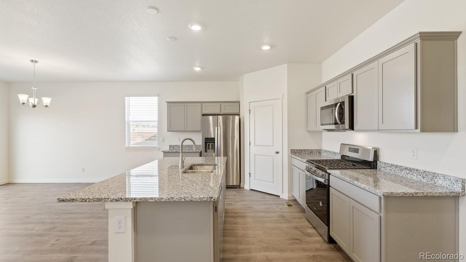 950 London Way Severance, CO 80550 - Photo 15 of 21 a kitchen with granite countertop a sink stove and refrigerator