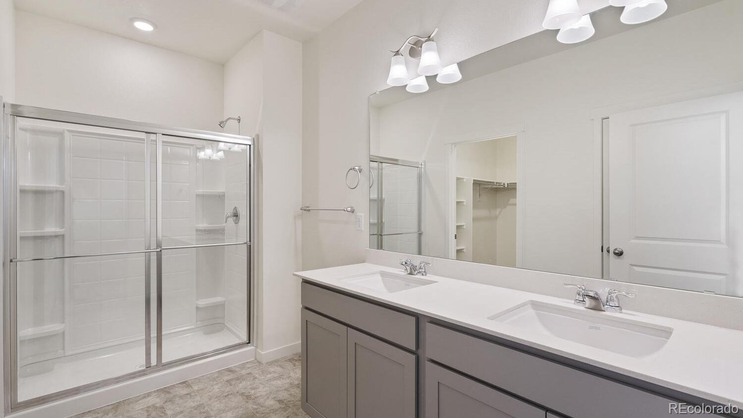 950 London Way Severance, CO 80550 - Photo 17 of 21 a bathroom with a double vanity sink mirror and shower