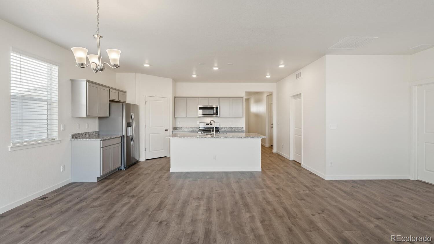 950 London Way Severance, CO 80550 - Photo 8 of 21 a view of kitchen with granite countertop cabinets and refrigerator