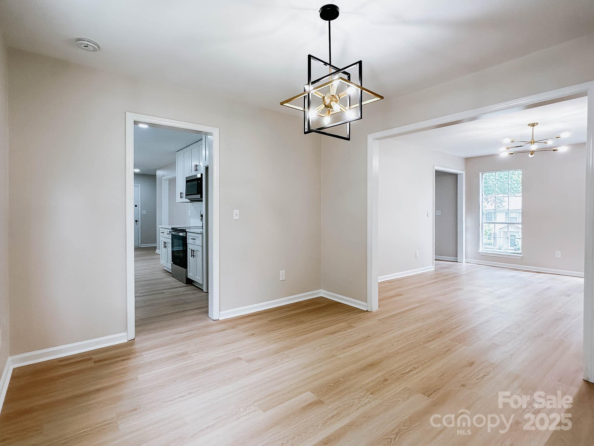 2105 Killarney Place Charlotte, NC 28262 - Photo 16 of 43 a view of a livingroom with a chandelier wooden floor and a chandelier