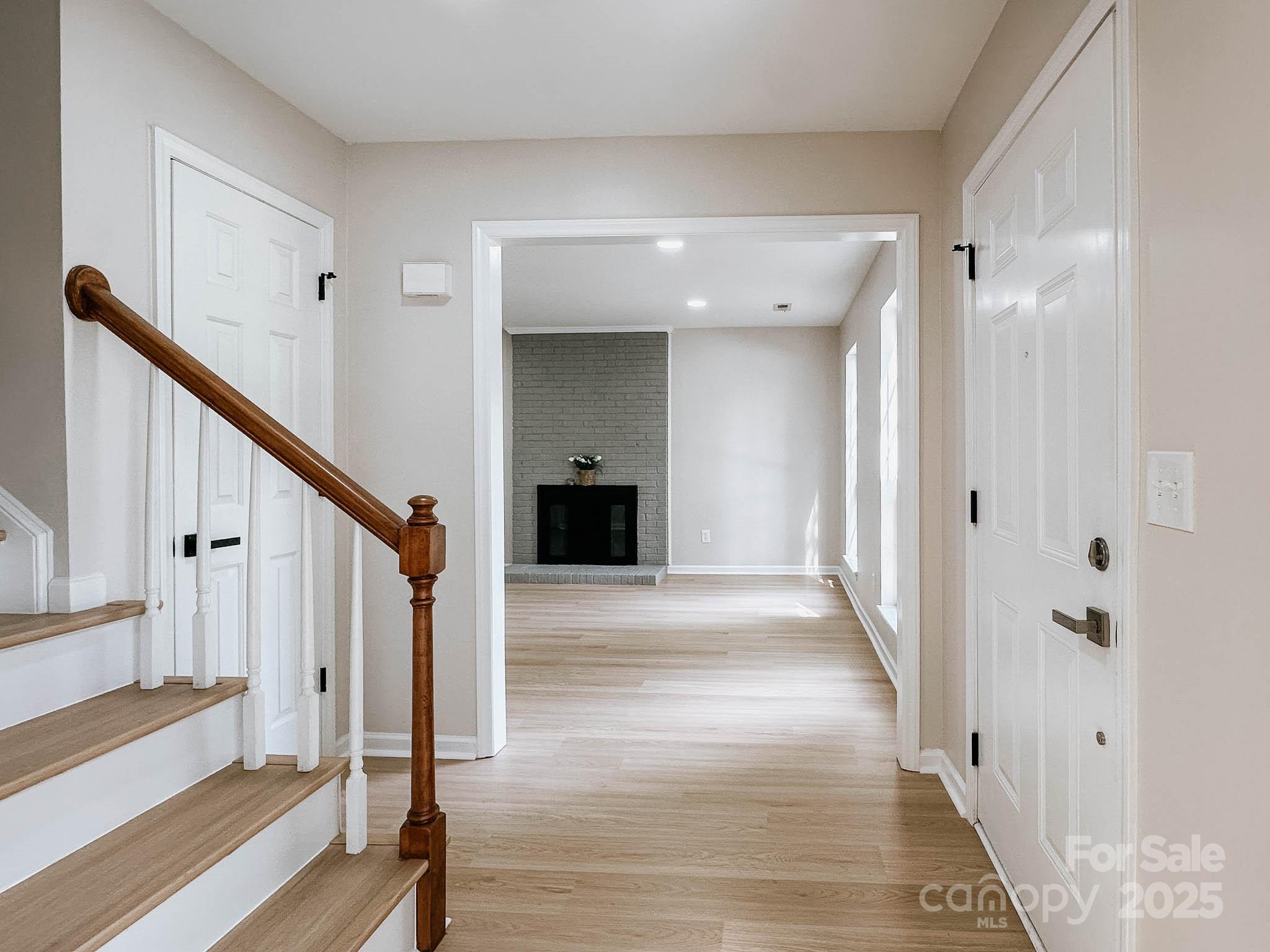 2105 Killarney Place Charlotte, NC 28262 - Photo 19 of 43 a view of a hallway view with wooden floor and staircase