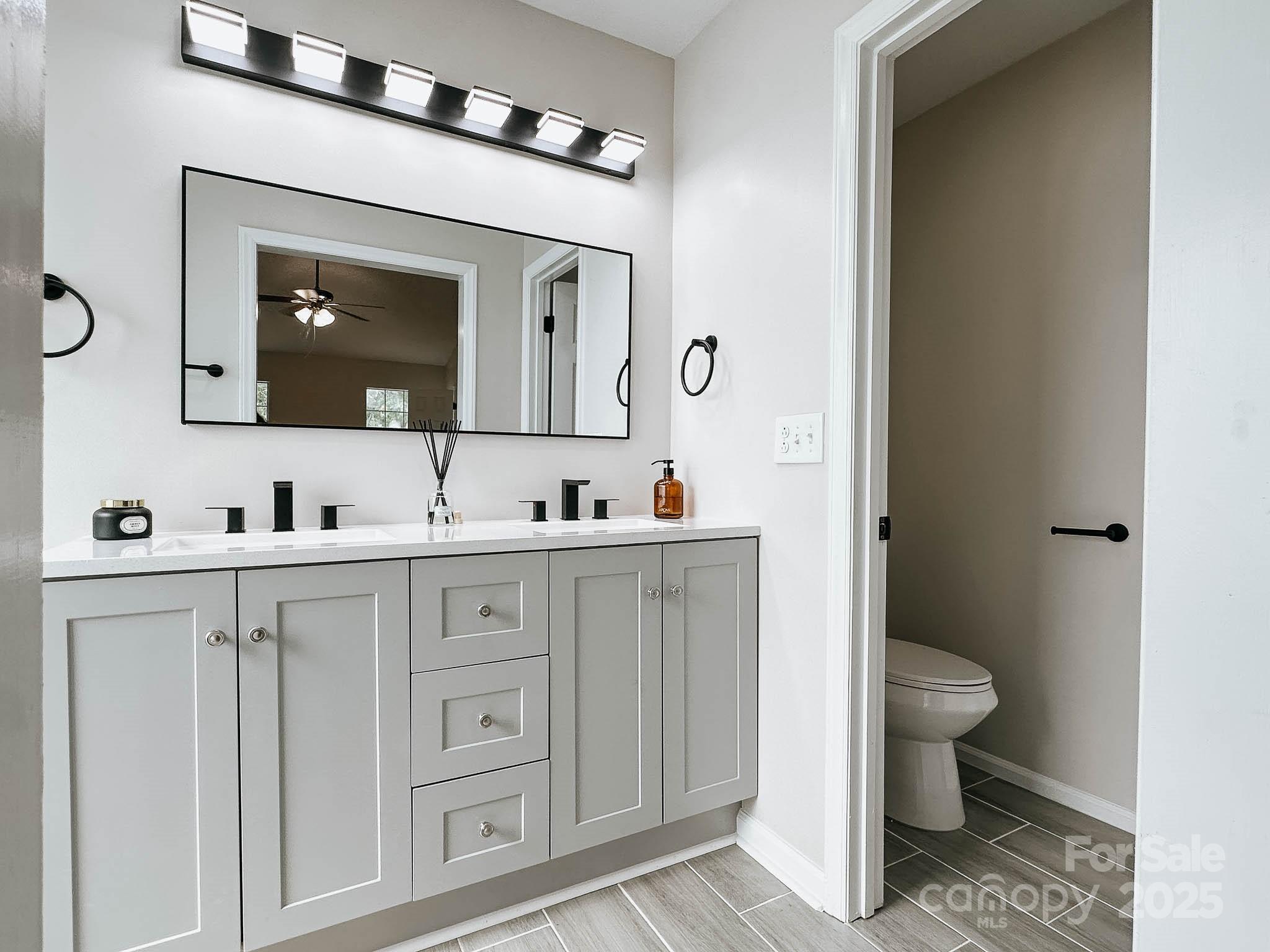 2105 Killarney Place Charlotte, NC 28262 - Photo 26 of 43 a spacious bathroom with a toilet sink and mirror