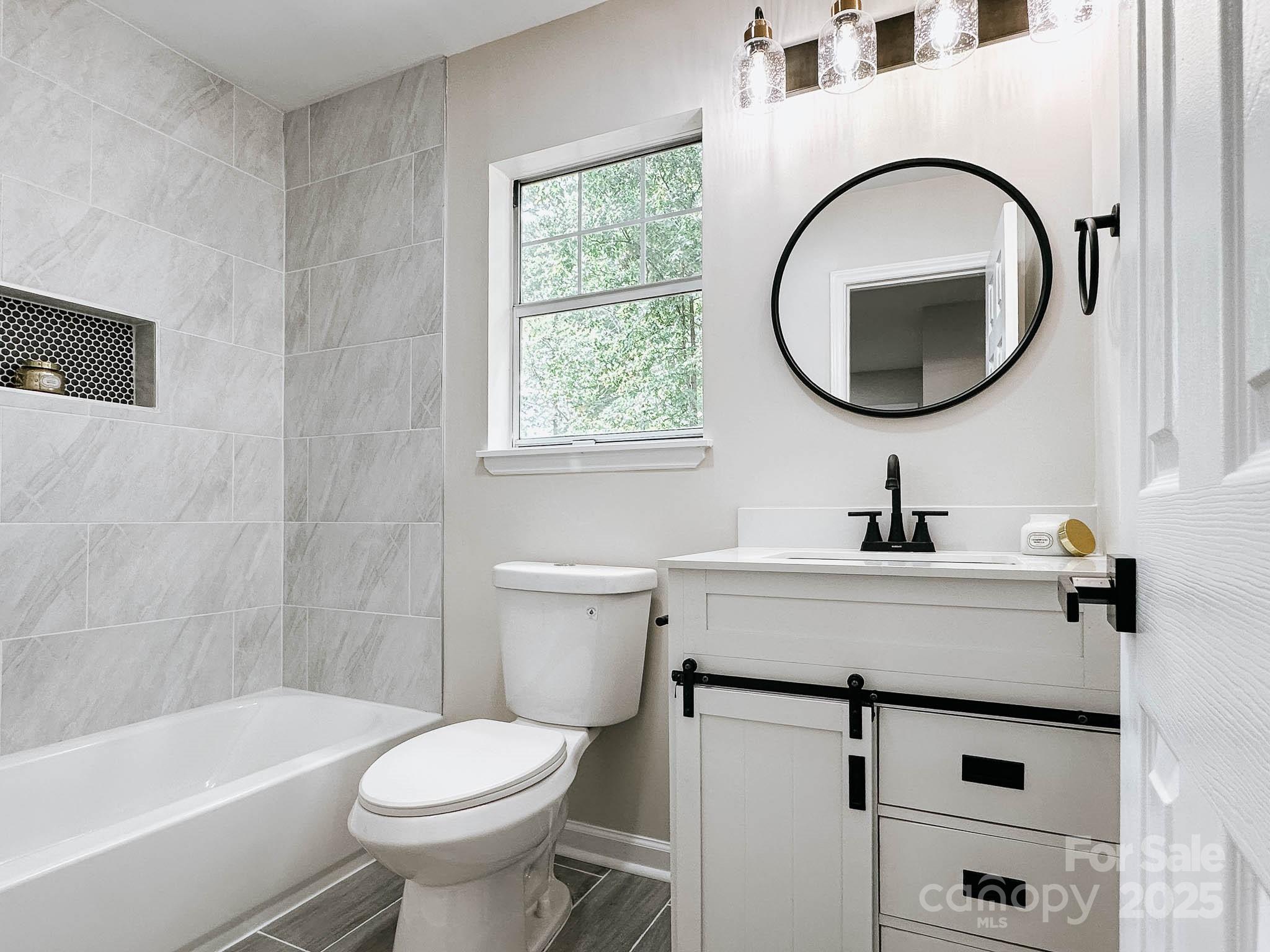 2105 Killarney Place Charlotte, NC 28262 - Photo 27 of 43 a bathroom with a sink a toilet and a mirror