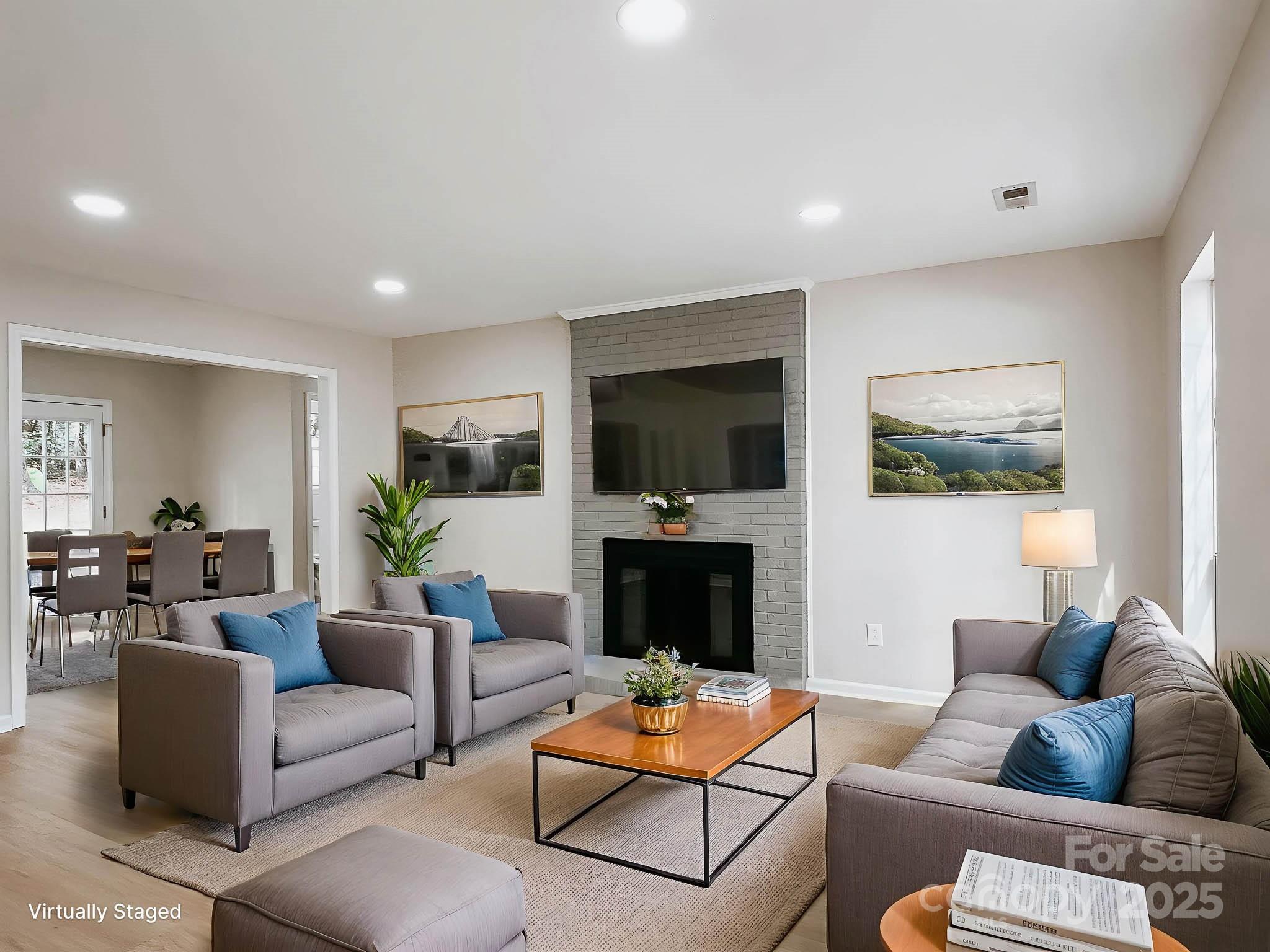 2105 Killarney Place Charlotte, NC 28262 - Photo 3 of 43 a living room with furniture a flat screen tv and a fireplace