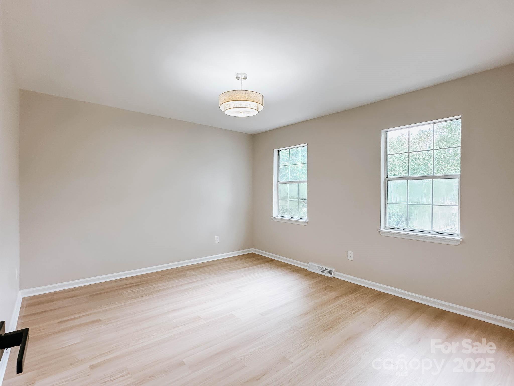 2105 Killarney Place Charlotte, NC 28262 - Photo 33 of 43 an empty room with wooden floor and windows