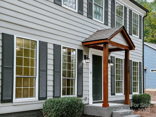 a view of brick house with large windows