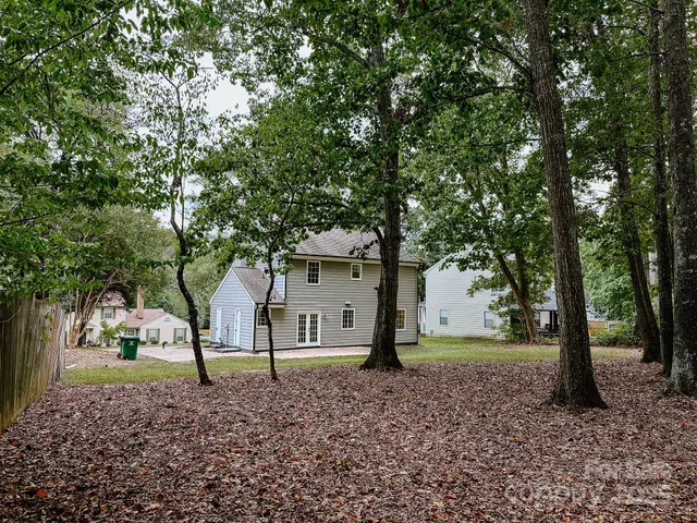 a view of a house with a tree in the background
