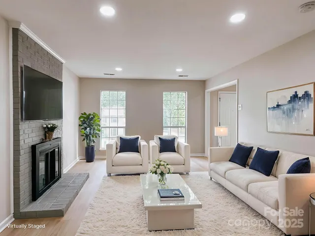 a living room with furniture flat screen tv and a fireplace
