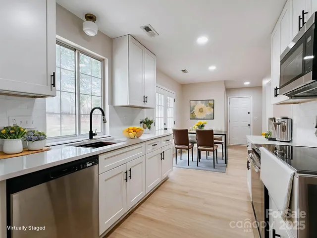 a kitchen with a sink stove and cabinets