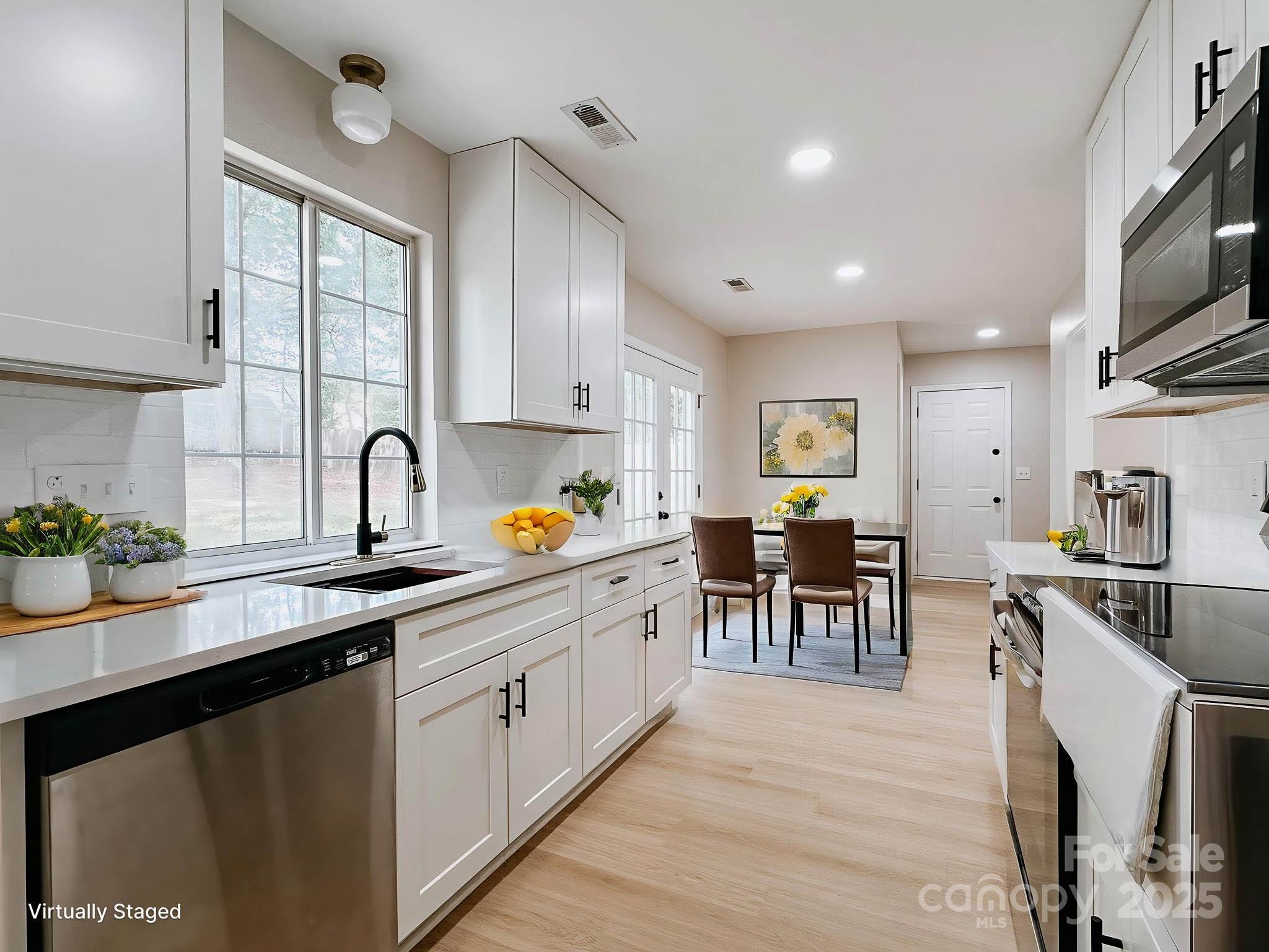 2105 Killarney Place Charlotte, NC 28262 - Photo 8 of 43 a kitchen with a sink stove and cabinets