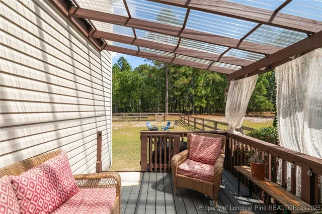 a view of a patio with couches chairs and wooden floor