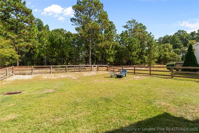 a view of a swimming pool with an outdoor seating and a yard