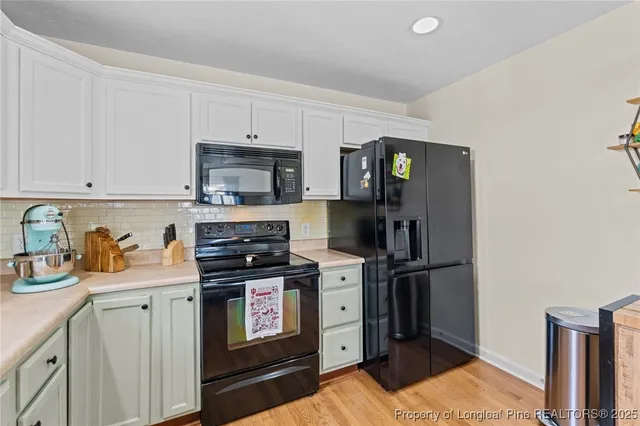 a kitchen with stainless steel appliances granite countertop a refrigerator stove and sink