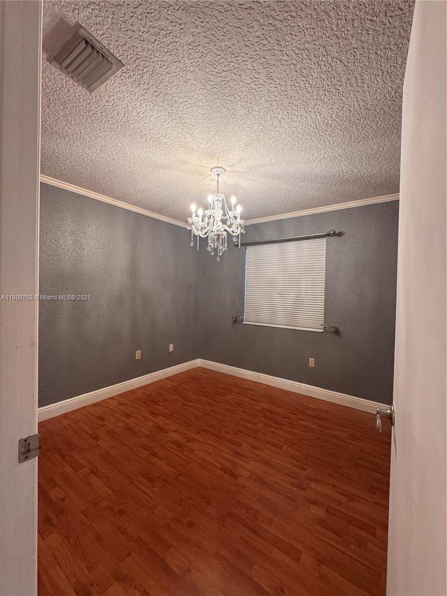 17910 Southwest 137th Court Miami, FL 33177 - Photo 15 of 25 a view of wooden floor and chandelier in a room