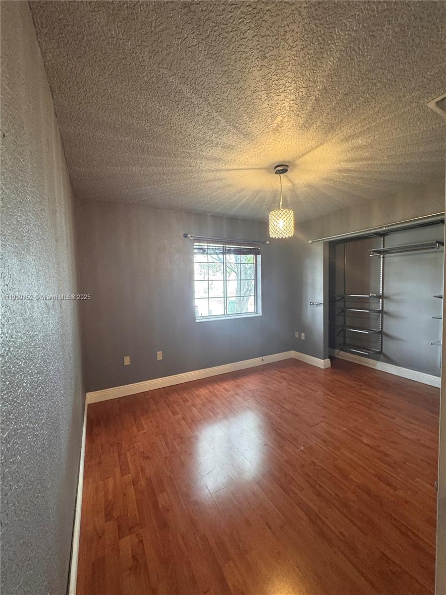 17910 Southwest 137th Court Miami, FL 33177 - Photo 19 of 25 an empty room with wooden floor and windows