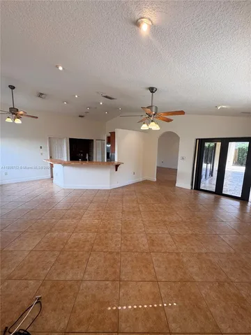 a view of a living room a ceiling fan and window