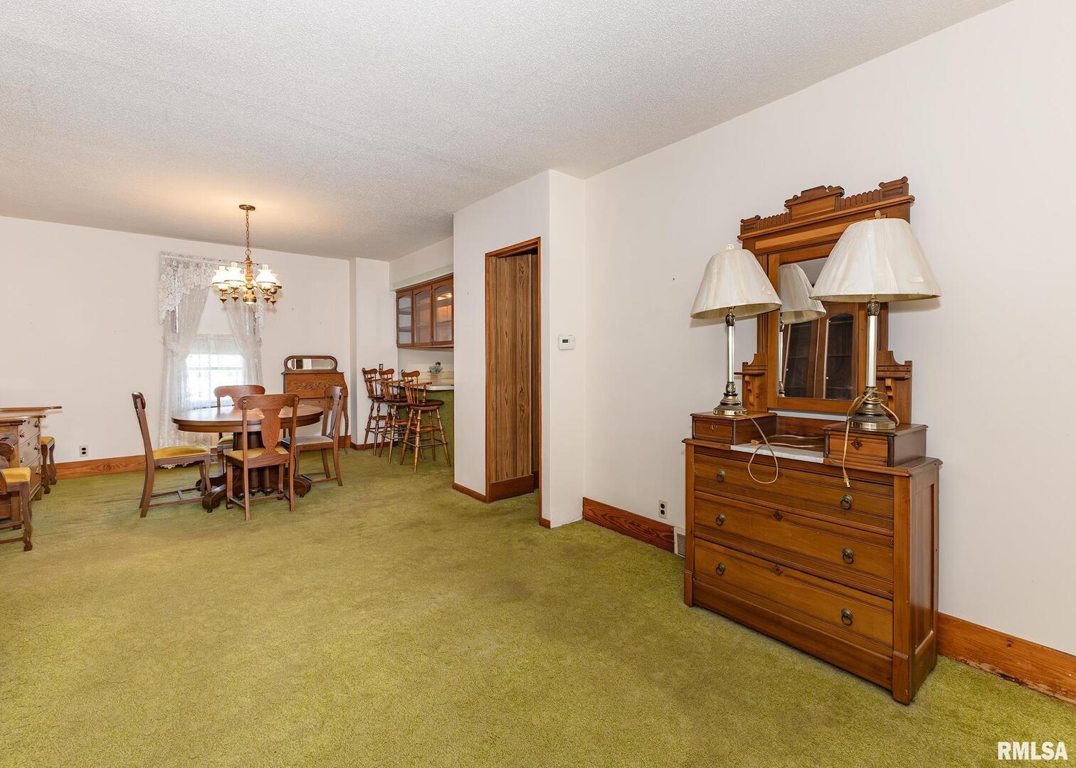 304 South 5th Avenue New Windsor, IL 61465 - Photo 11 of 29 a view of a workspace with furniture and a chandelier