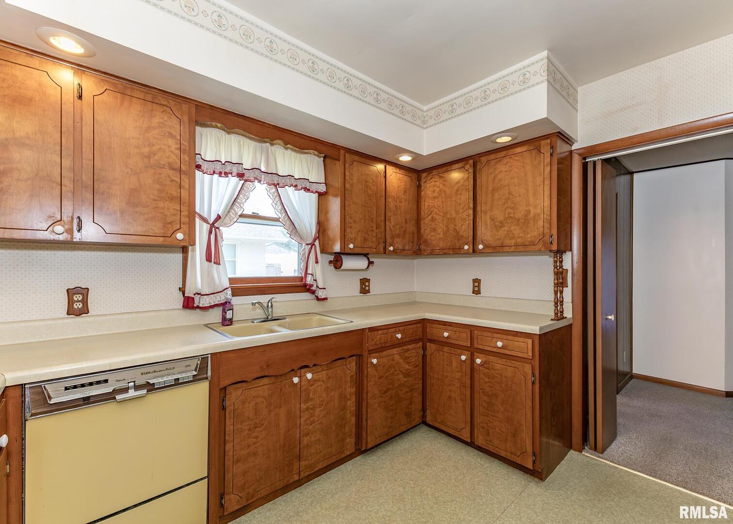 304 South 5th Avenue New Windsor, IL 61465 - Photo 4 of 29 a kitchen with a sink window and cabinets